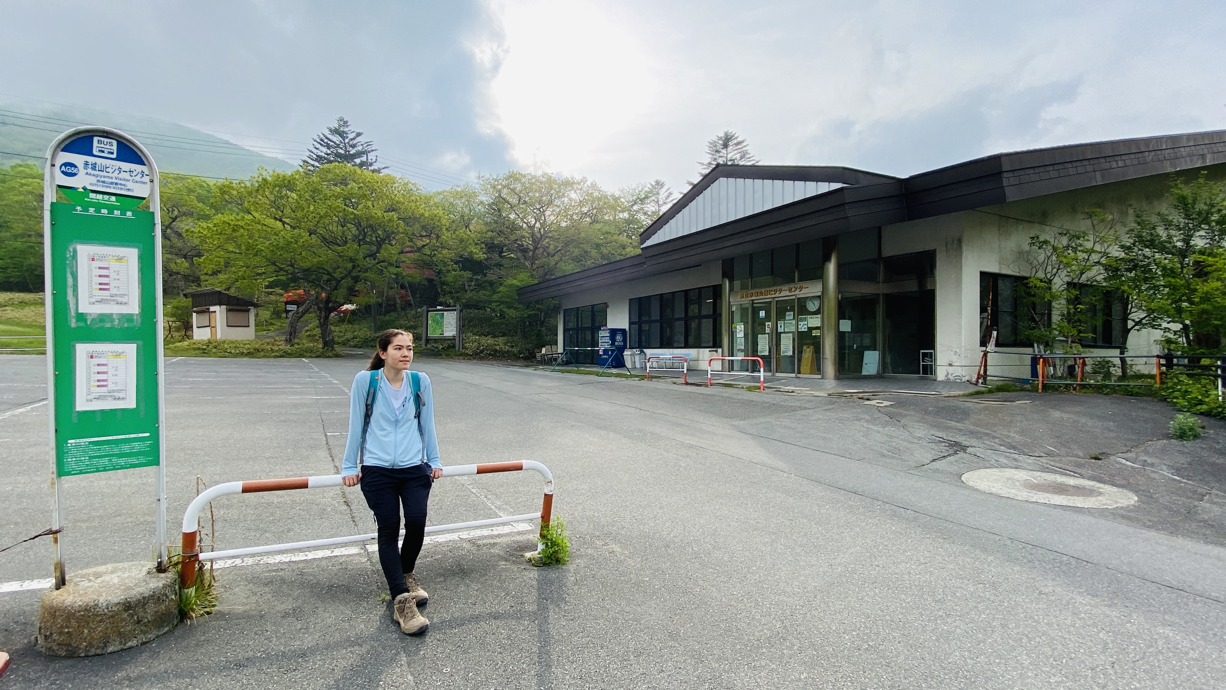 hiker waits at bus stop next to Akagi visitor center