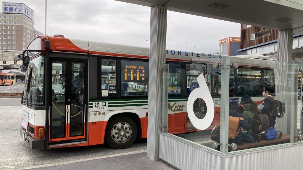 A bus pulled up to a covered bus stop