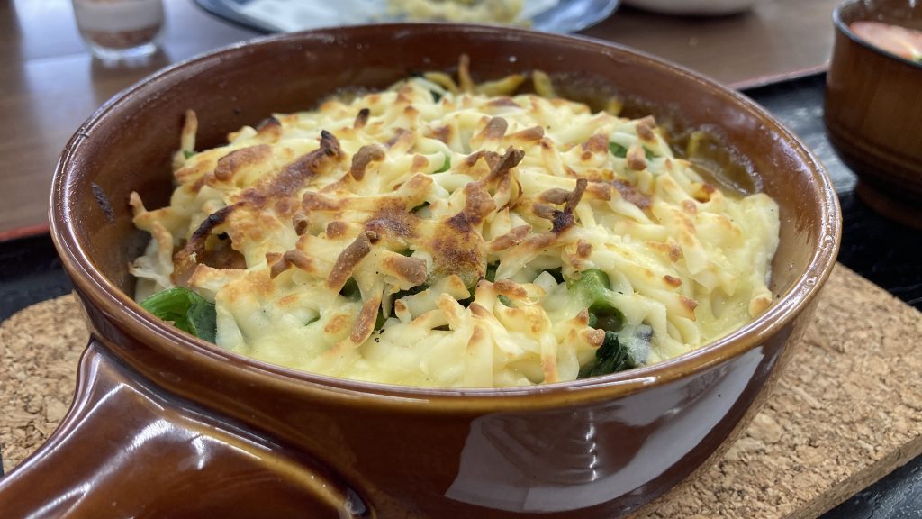 A casserole dish with casserole covered in cheese