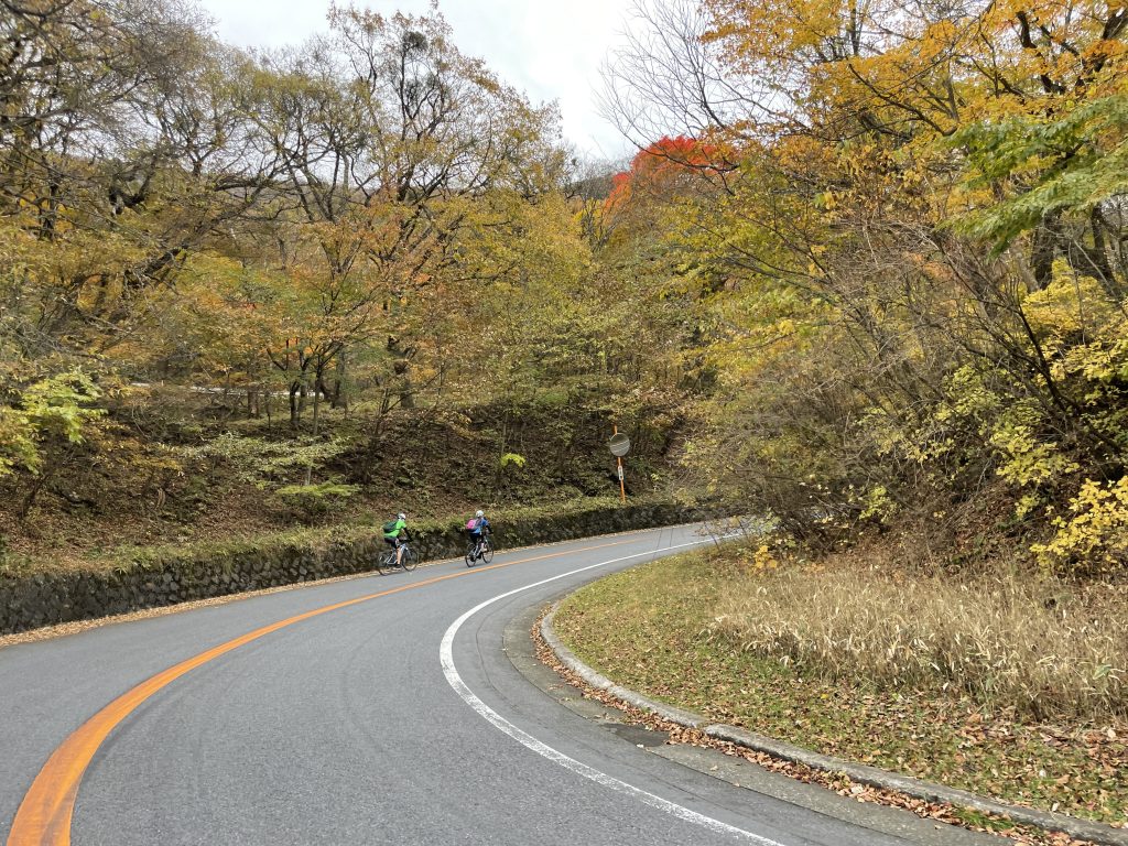 Cyclists riding up around a switchback