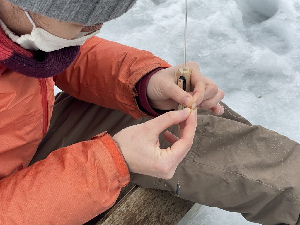 Putting bait on a fishing hook