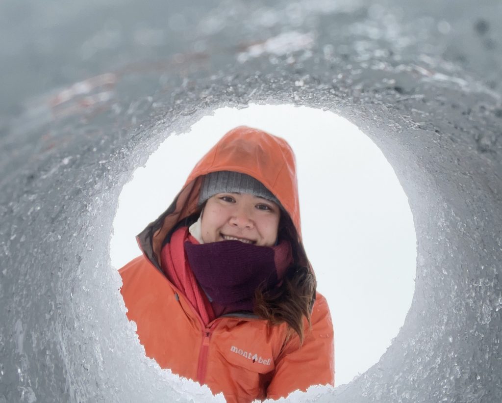 Someone looking into a hole in the ice