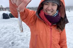 Woman holding a small fish