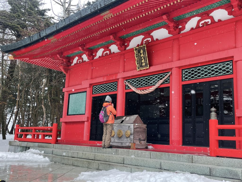 A person praying at a Japanese shrine